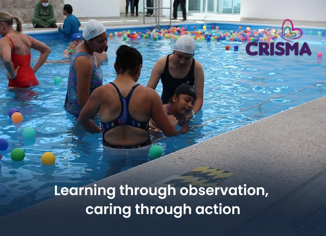 CRISMA physical therapists assisting a child during hydrotherapy for the shadowing program learning